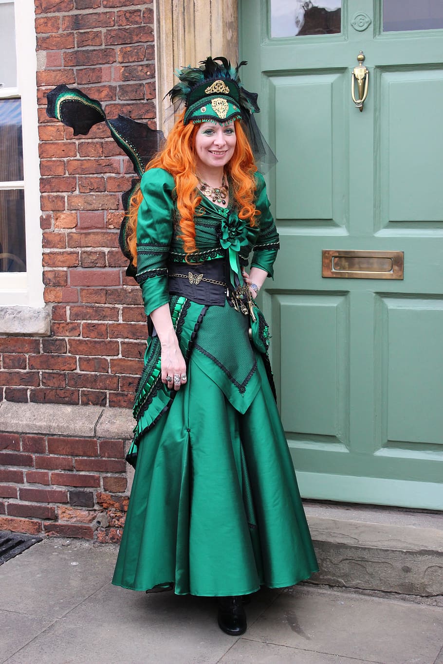 woman, wearing, green, black, scoop, neck, long-sleeve, bow, accent, gown