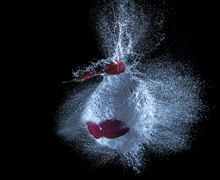 balloon, water, dart, blowout, black background, studio shot, motion, indoors, splashing, one person