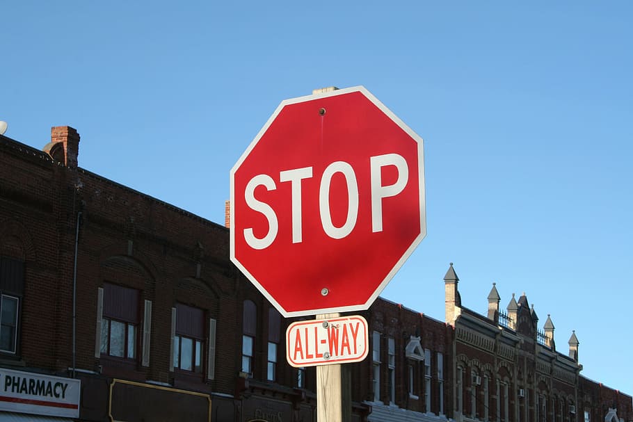 stop sign, city, town, traffic, road, sign, text, communication, road sign, building exterior