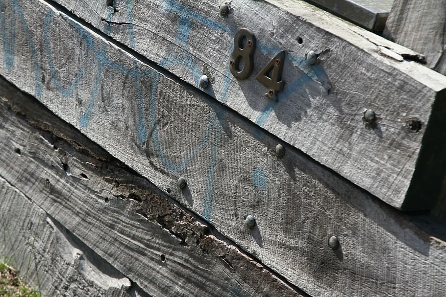 number 84, wood, pine sleepers, fence, wooden fence, weathered fence, house number, wood texture, old fence, rustic fence