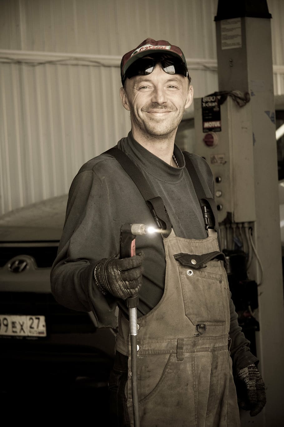 man, holding, welding torch, mechanic, plasmatic cutter, car service, looking at camera, standing, one person, portrait