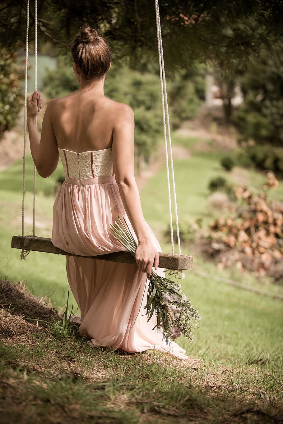 woman, wearing, pink, strapless dress, sitting, brown, sing, daytime, blur, design