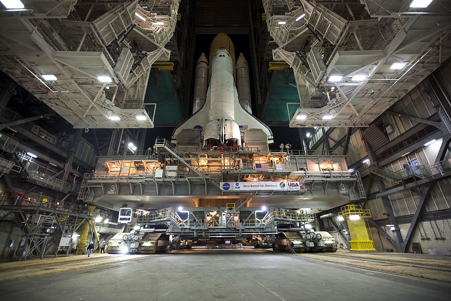 low, angle photo, space shuttle, inside, building, discovery space shuttle, rollout, launch pad, pre-launch, astronaut