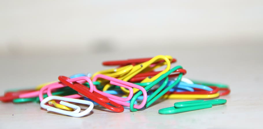 assorted-color plastic paper clips, white, surface, macro, photography, paper clip, wallpaper, multi Colored, close-up, equipment