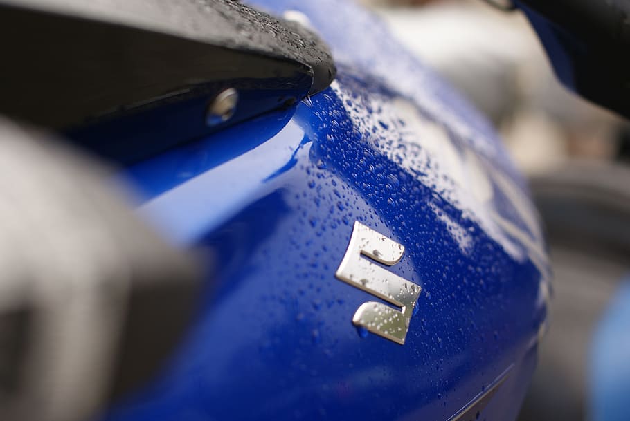 logo, motorcycle, outline, selective focus, close-up, blue, metal, focus on foreground, indoors, car