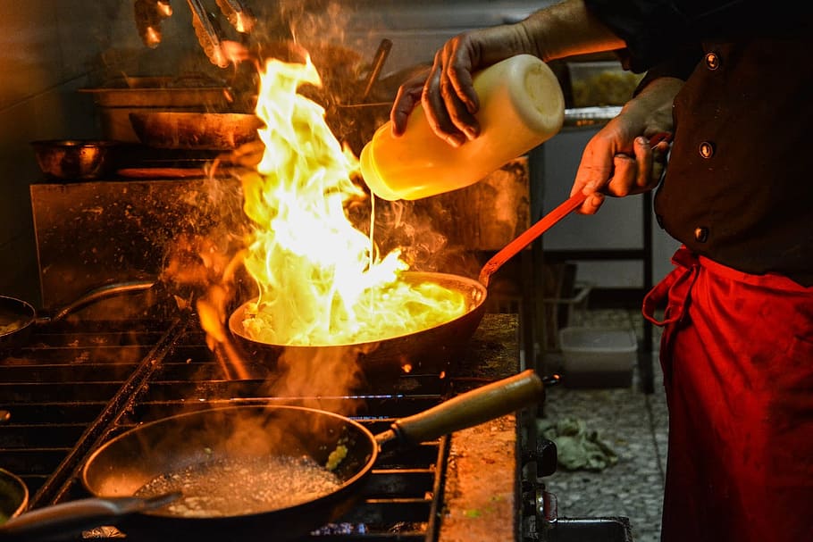 person cooking, black, frying, pan, fire, top, service, chef, seafood, food