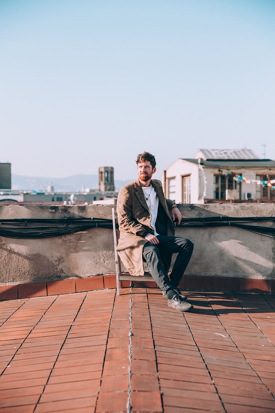 man, fashion, rooftop, city, buildings, sitting, person, chair, architecture, outdoors