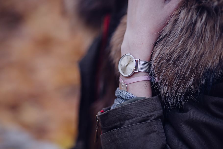 person, wearing, round gold-colored analog, watch, adult, blur, fashion, fur, girl, hand