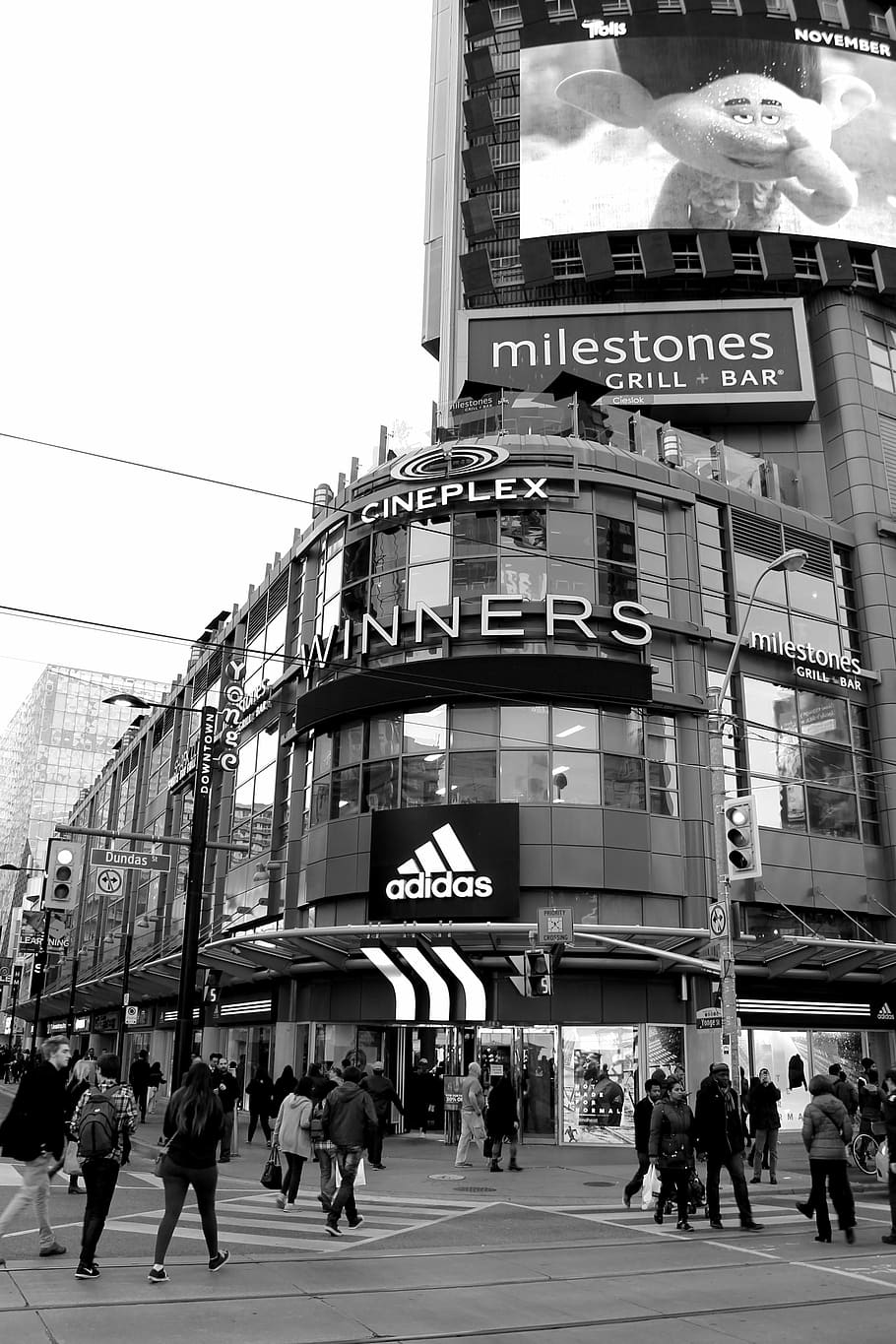 cineplex winners signboard, winners, building, grayscale, photography, monochrome, black and white, urban, city, people