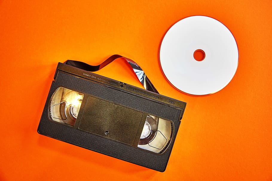vhs, dvd, videokasette, orange, colored background, studio shot, orange color, indoors, orange background, close-up