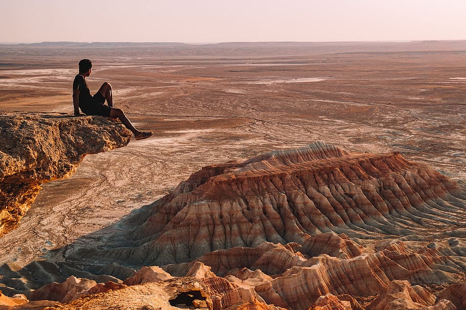 man, sitting, rock, desert, landscape, dry, geology, nature, erosion, dawn