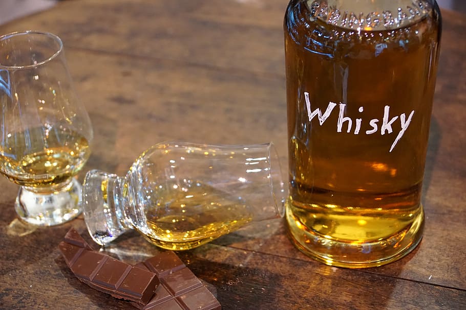 whisky bottle, two, clear, drinking glasses, chocolate bar, brown, wooden, surface, whisky, single malt