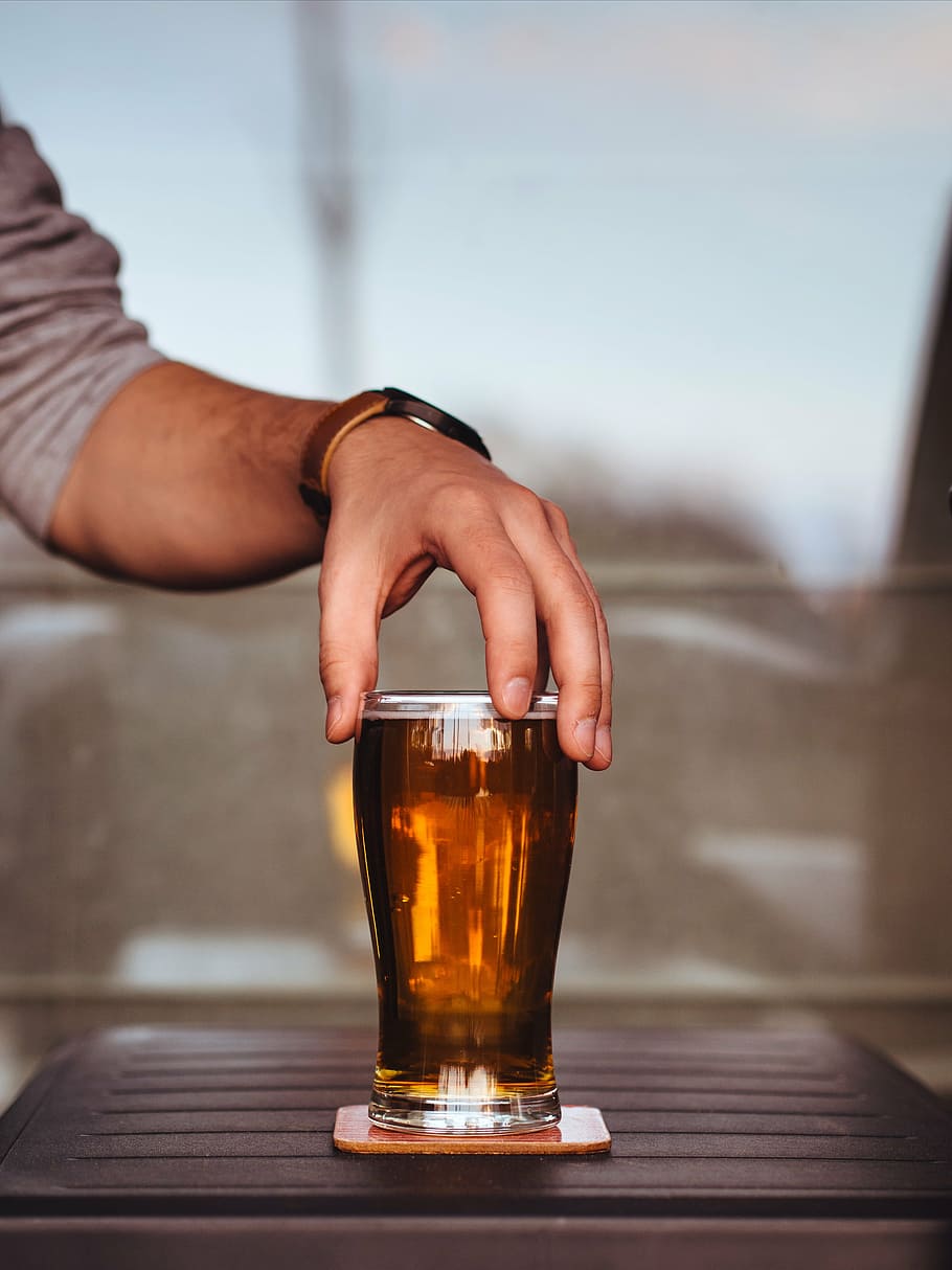 person, holding, tint, glass, filled, brown, liquid, alcohol, beer, drink