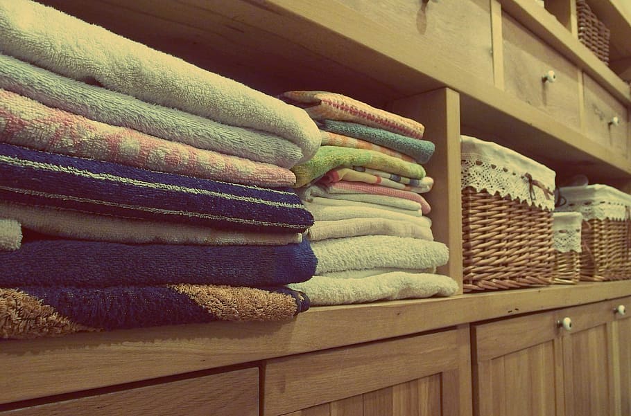 assorted-color towels, wooden, shelf, towels, dresser, cupboards, room, decor, clothing, textile