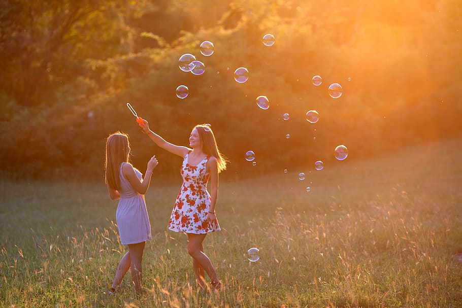 two, women, wearing, mini dresses, playing, bubbles, grass field, girls, girl, sunset