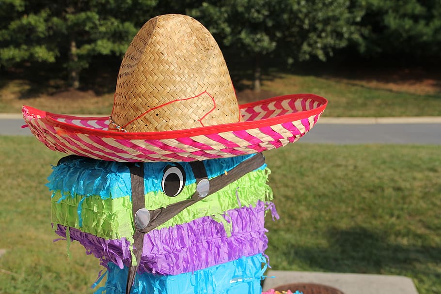 multicolored, pinata, wearing, hat, daytime, piniata, sombrero, fiesta, focus on foreground, clothing