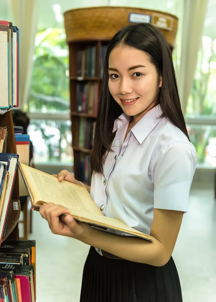 woman, whiteblouse, black, shirt, holding, book, library, students, study of, classmate