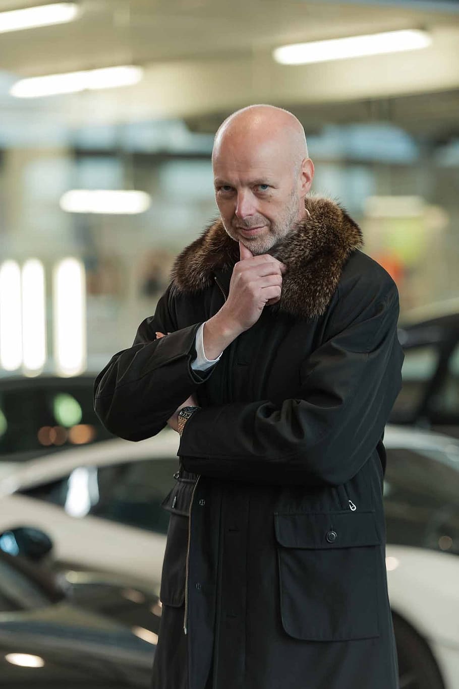 man, wearing, black, coat, standing, car parking lot, lights turned-on, businessman, auto, lamborghini