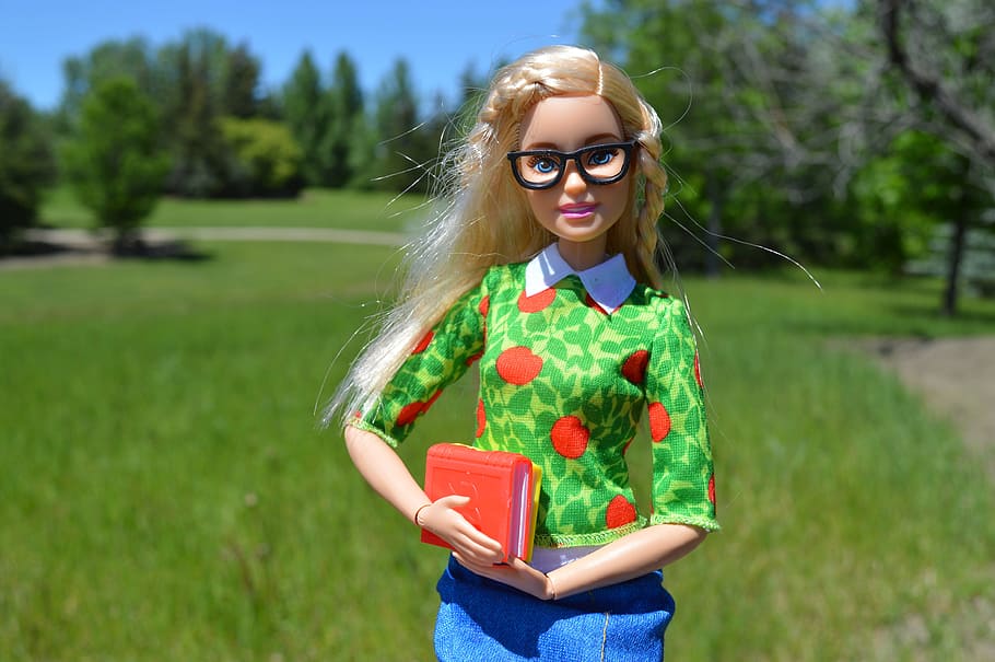 barbie doll action figure, front, green, grass field, barbie, doll, books, glasses, blonde, student