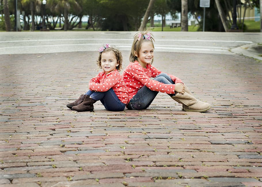 two, girls, red, polka dot sweater, sitting, paver bricks, sisters, kids, children, daughter