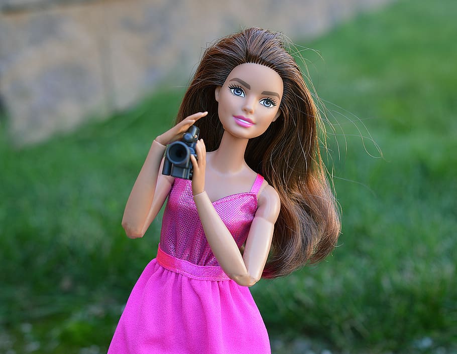 close-up photo, barbie doll, holding, camera, barbie, doll, video camera, film, filming, toy
