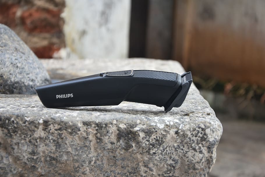 trimmer on a stone, philips trimmer, black trimmer, focus on foreground, rock, rock - object, solid, day, close-up, outdoors