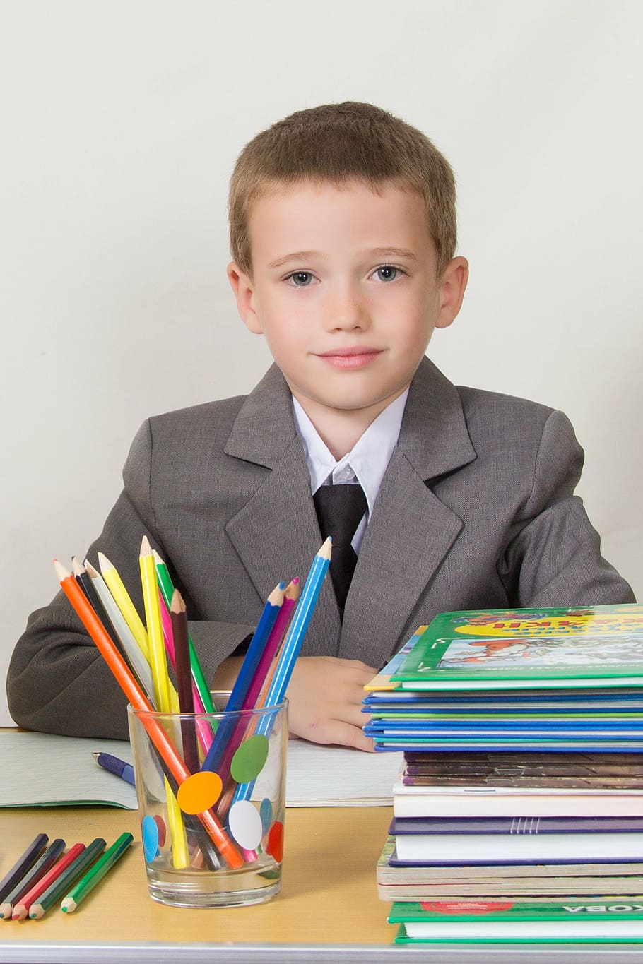 schoolboy, at the desk, sitting, books, pencils, bright, notebook, child, education, learning