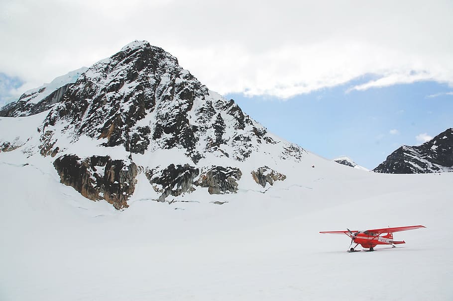 red, stunt plane, snowy, mountain, monoplane, snow, daytime, mountains, winter, cold