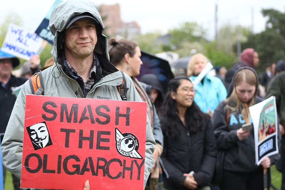 person, holding, smash, oligarchy sign, outdoor, daytime, Protest, Oligarchy, March, Activism