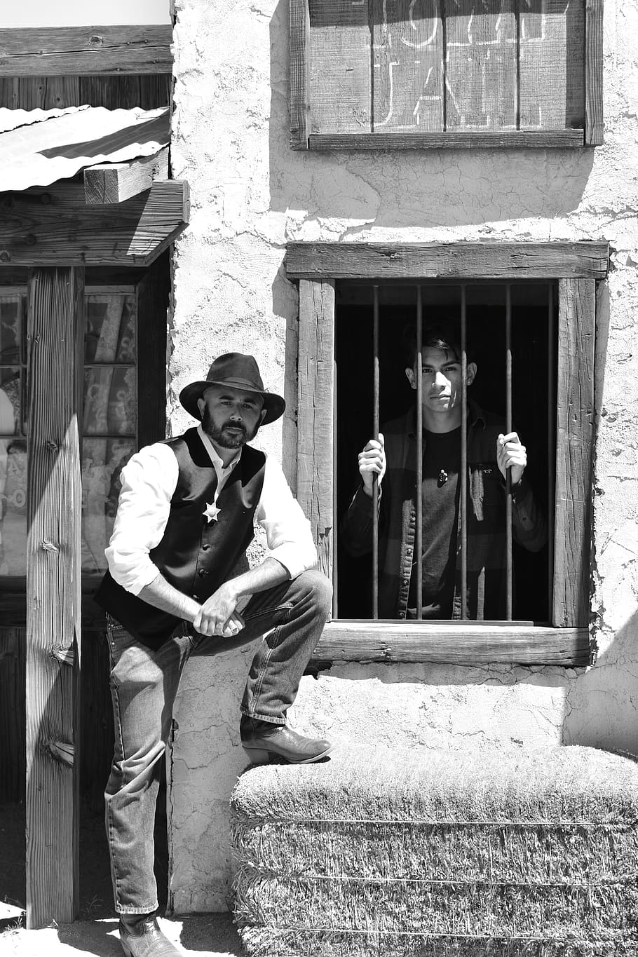 man, wearing, black, fedora hat, cowboy, western, jail house, wild, west, black and white