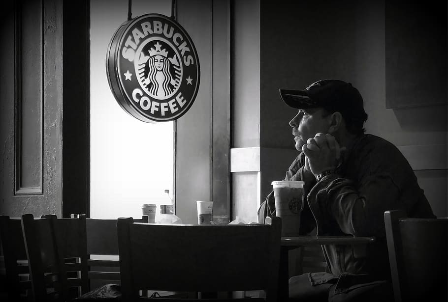 grayscale photo, man, sitting, table, starbucks poster, street, coffee, café, starbucks, street photography