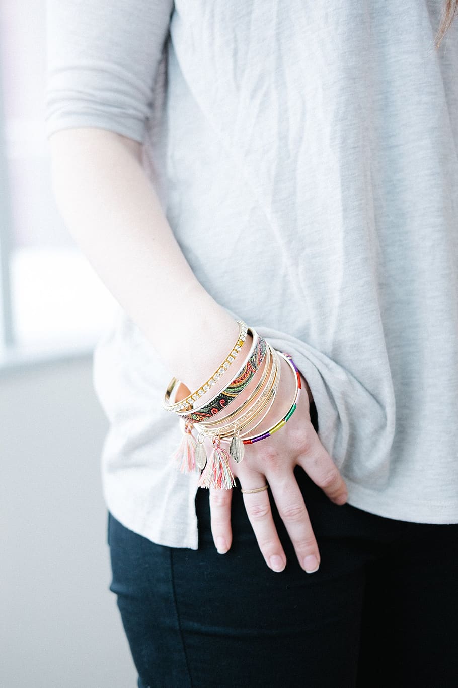 hand, pocket, woman, adult, casual, bracelets, jewelry, person, shirt, pants