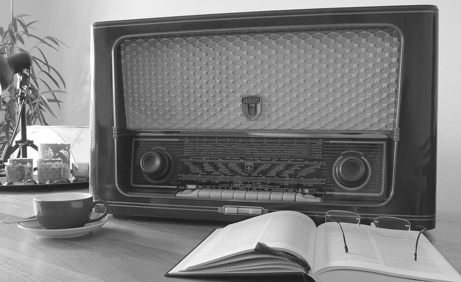 grayscale photography, transistor radio, table, opened, book, eyeglasses, radio, nostalgia, old, receiver