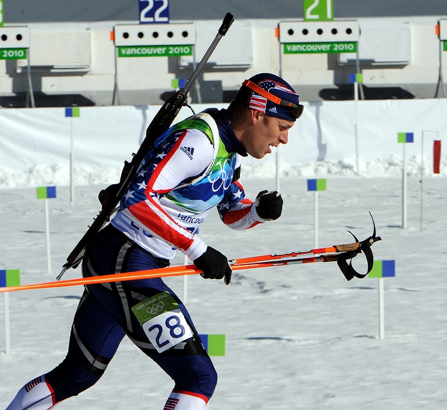 man, wearing, ice hockey suit, holding, pole, running, biathlon, competitor, athlete, skiing
