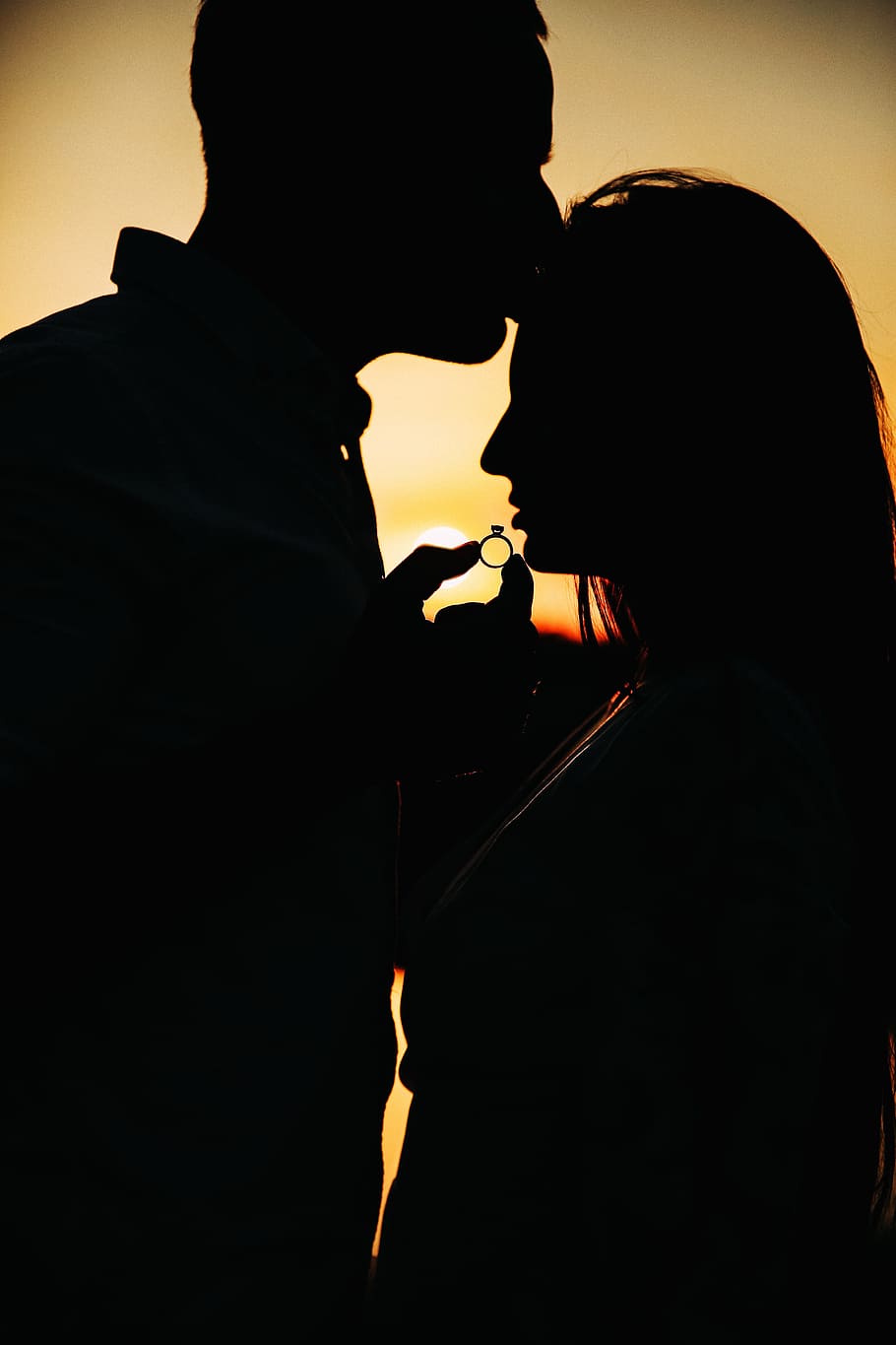 silhouette, couple, holding, ring, golden, hour, portrait, wedding, kiss, photoshoot