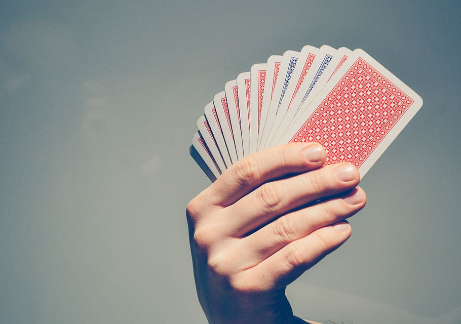 A hand showcasing a fan of playing cards, anticipating a card trick.