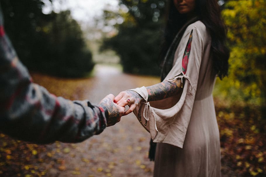 woman, holding, man, hand, standing, green, leafed, tree, focus, photography