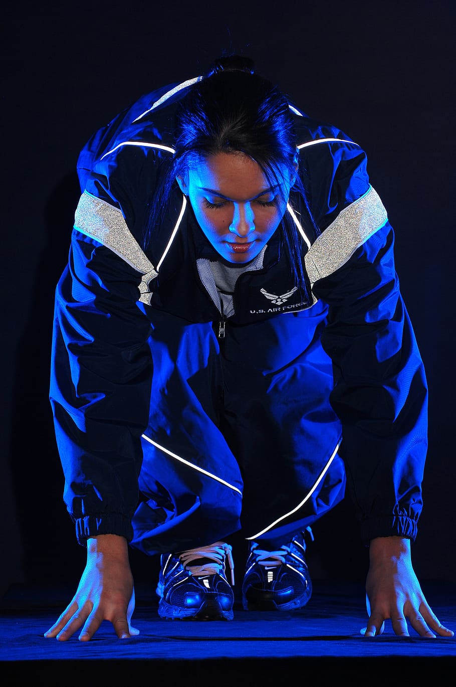 close-up photograph, woman, wearing, blue, zip-up jacket, runner, start, athlete, jogging, sprinter