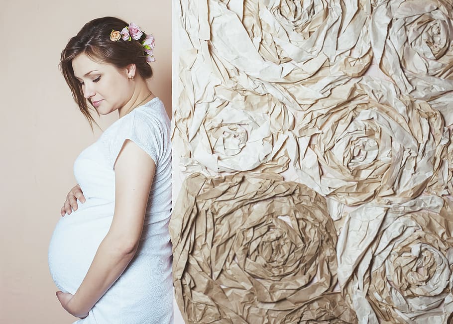 pregnant, woman, holding, tummy, leaning, brown, wall, pregnancy, waiting for the miracle of birth, the birth of