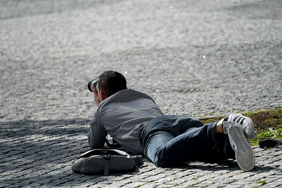man, holding, dslr camera, photographer, in action, action, human, camera, lying, on the ground