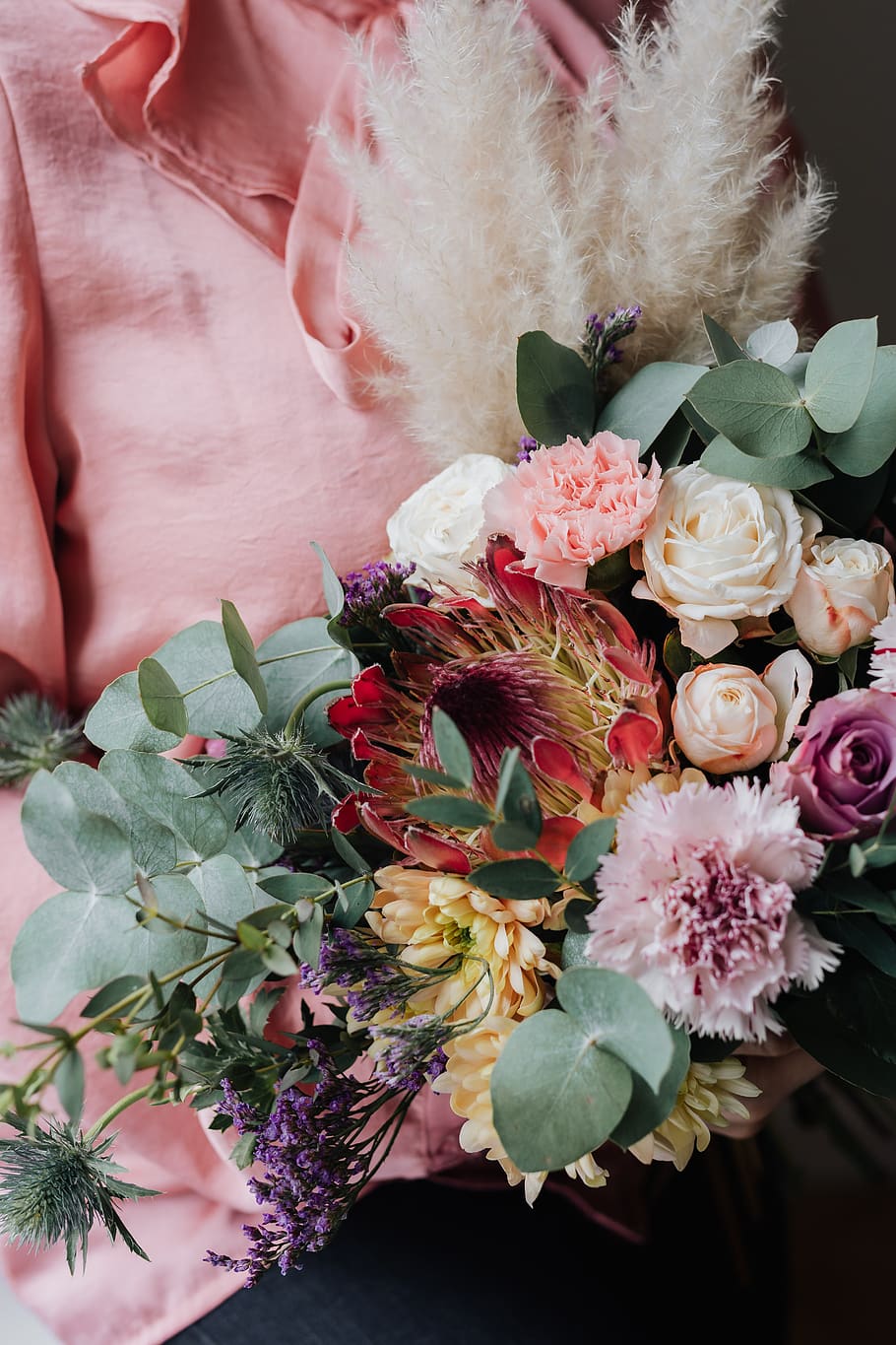woman, bouquet, flowers, protea, eucalyptus, Dianthus, carnation, rose, Cortaderia selloana, wrapped