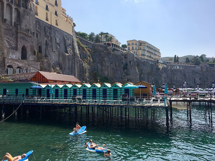 people, floaters sunbathing, daytime, sorrento, amalfi coast, italy, water, architecture, building exterior, built structure
