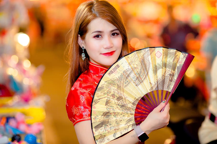 woman, red, top, holding, hand fan, smiling, portrait, girl, night, face