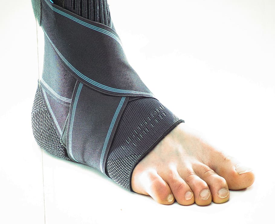 close-up photo, right person foot, wearing, black, band, Foot, Toes, Strain, Bandage, human body part