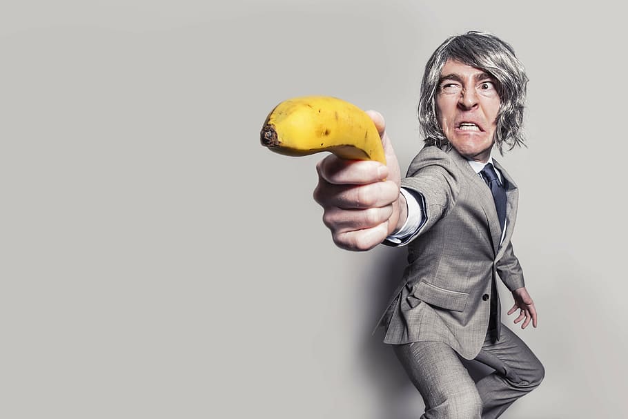 person, wearing, suit, holding, banana, wall, business man, business, man, male