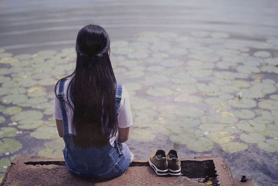 woman, sitting, brown, wooden, dock, pair, gray, low-top sneakers, so sad, water