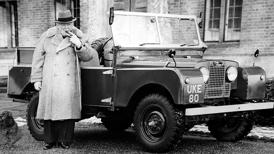 grayscale photo, man, front, vehicle, wearing, button-up coat, churchill, old photo, history, monochromatic