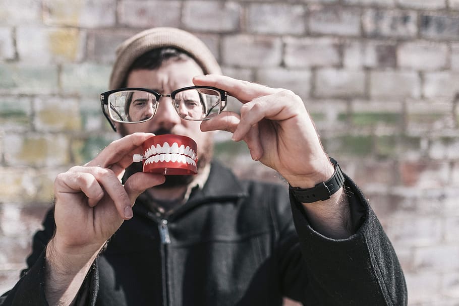 person holding eyeglasses, person, eyeglasses, whimisical, people, lazy, glasses, smile, teeth, happy