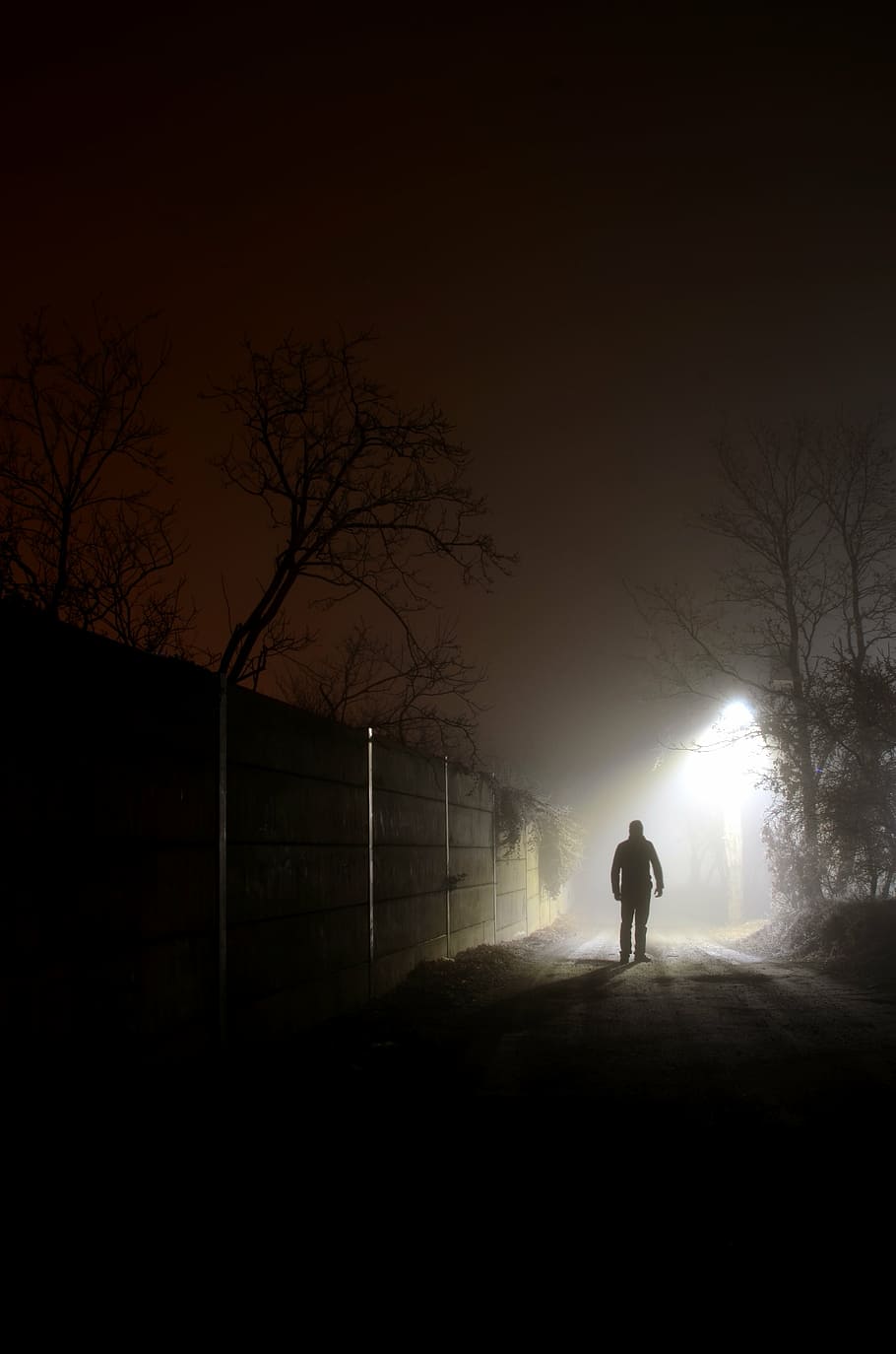 silhouette photography, man, walking, wall, street igh, at night, foreign, light, fog, fearful