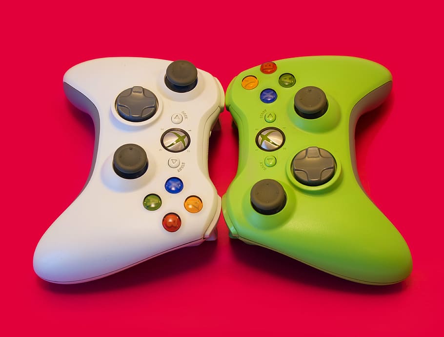 white, green, xbox game pads, joystick, controller, xbox 360, raspberry background, colored background, studio shot, indoors